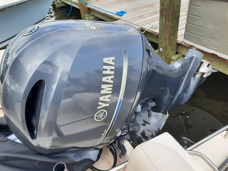 Slide: The Image of Yamaha outboard motor on 2016 Grady-White Freedom 205 boat, docked by wooden pier. - 27
