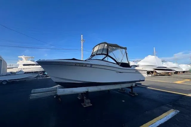 Slide: The Image of 2016 Grady-White Freedom 205 boat on display at a marina under clear blue skies. - 30
