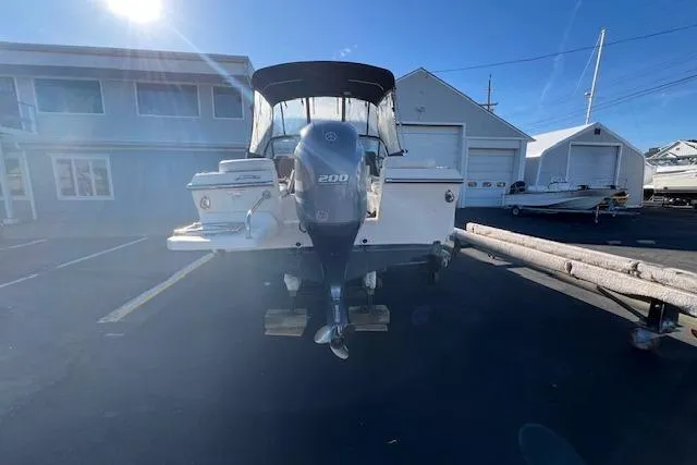 Slide: The Image of 2016 Grady-White Freedom 205 boat with Yamaha 200 engine in a marina setting. - 33