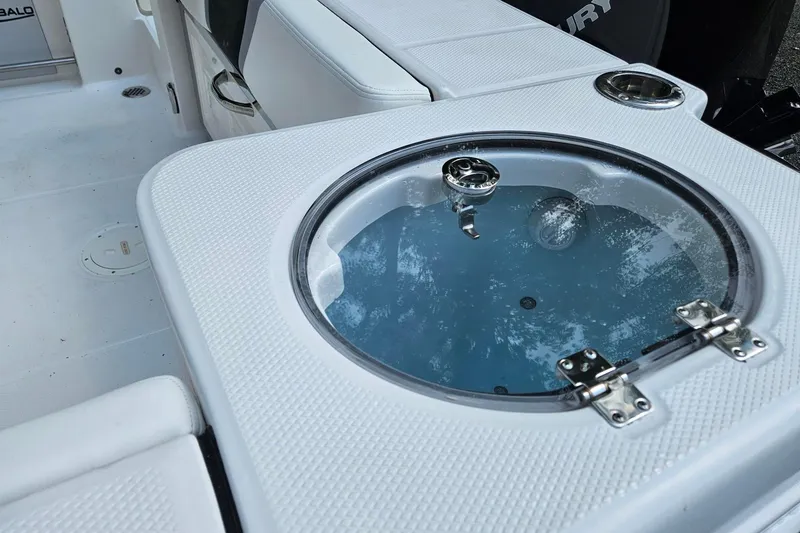 Slide: The Image of 2025 Robalo R230 Center Console boat with livewell and seating area. - 10