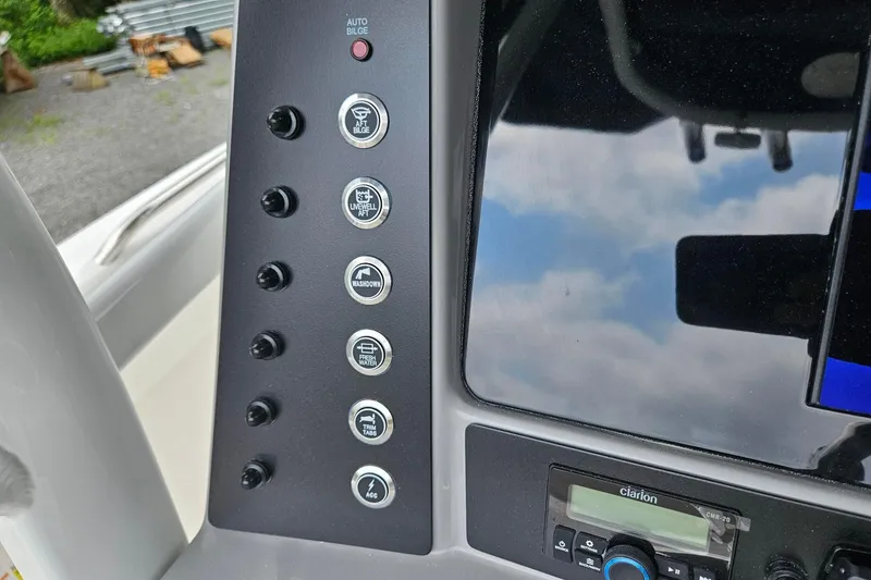 Slide: The Image of Control panel of 2025 Robalo R230 Center Console boat with various function buttons. - 14