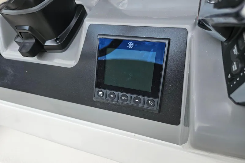 Slide: The Image of 2025 Robalo R230 Center Console dashboard with digital display and controls. - 17