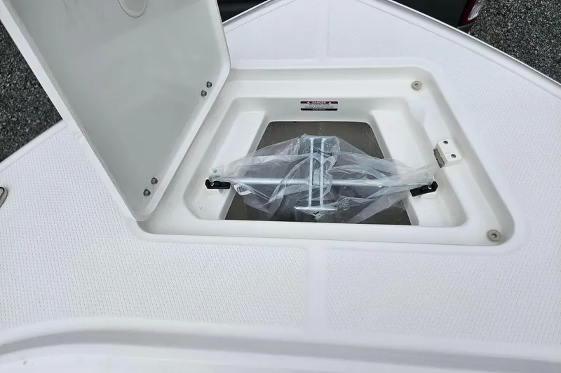 Slide: The Image of Open storage compartment on 2025 Robalo R230 Center Console boat. - 28