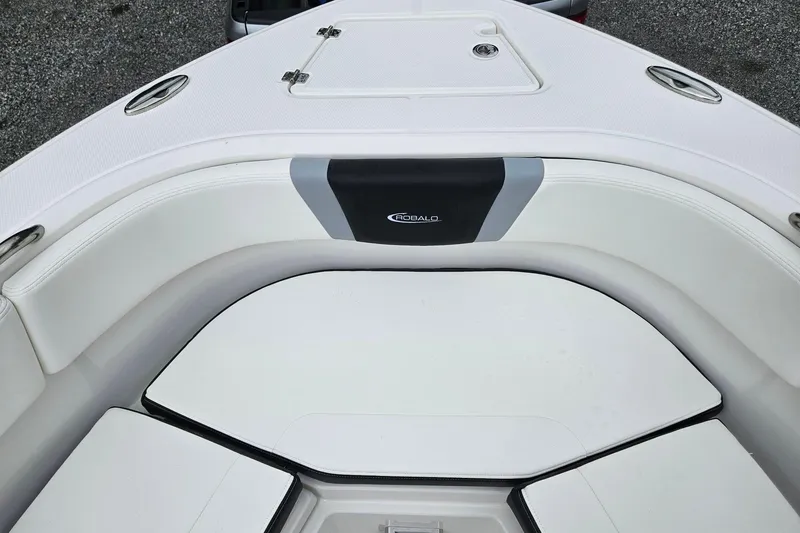 Slide: The Image of 2025 Robalo R230 Center Console boat interior with cushioned seating and storage compartments. - 29