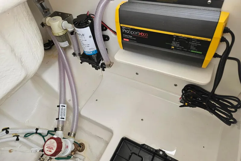 Slide: The Image of 2025 Robalo R230 Center Console boat interior with ProSportHD20 charger and plumbing components. - 37