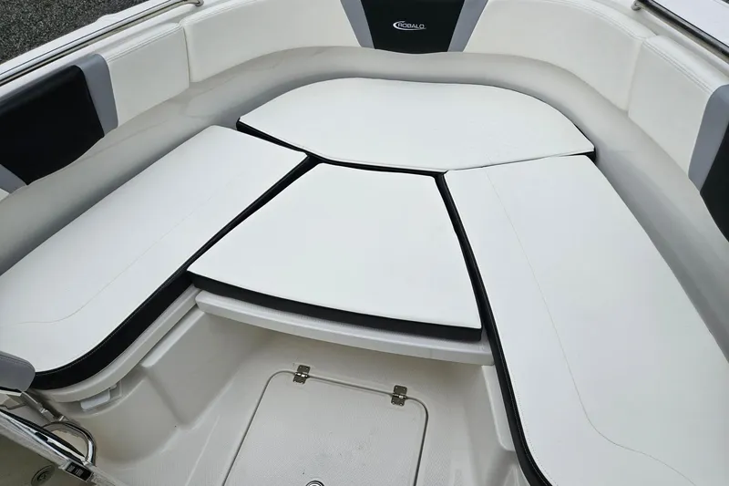 Slide: The Image of 2025 Robalo R230 Center Console boat interior with cushioned seating area. - 5