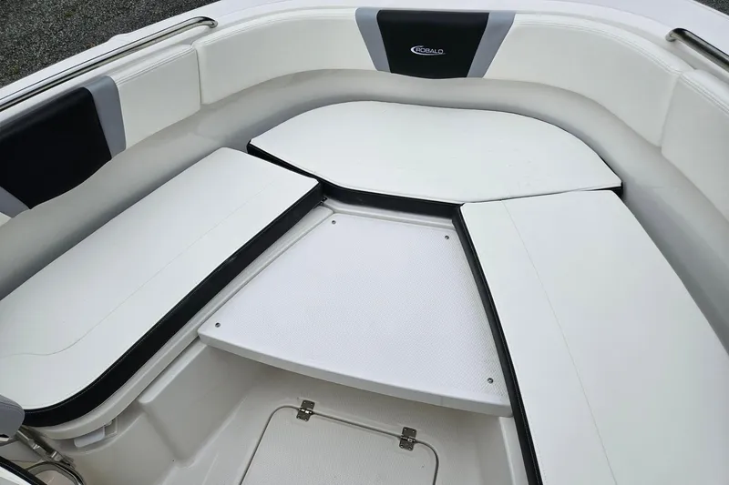 Slide: The Image of 2025 Robalo R230 Center Console boat interior with cushioned seating. - 6