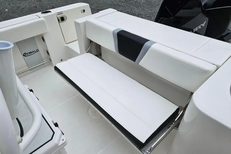 Slide: The Image of 2025 Robalo R230 Center Console boat interior with white seating and storage. - 9