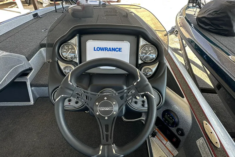 Slide: The Image of 2026 Triton 179 TrX boat dashboard with Lowrance display and steering wheel. - 15