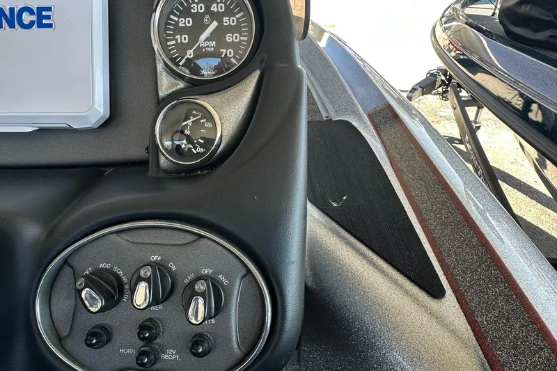 Slide: The Image of Dashboard of 2026 Triton 179 TrX boat with gauges and control switches. - 16