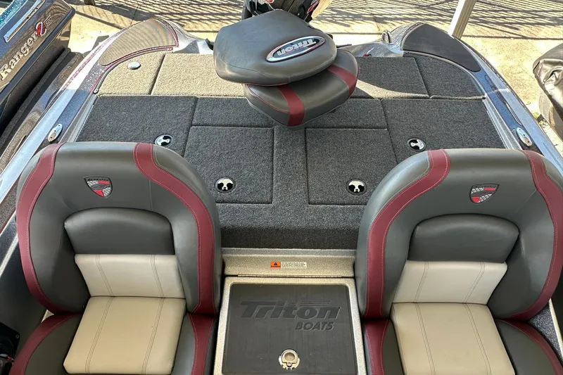 Slide: The Image of 2026 Triton 179 TrX boat interior with dual seats and carpeted deck. - 21