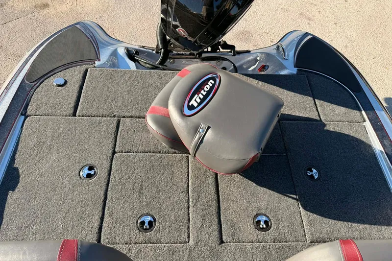Slide: The Image of 2026 Triton 179 TrX boat deck with cushioned seat and storage compartments. - 22
