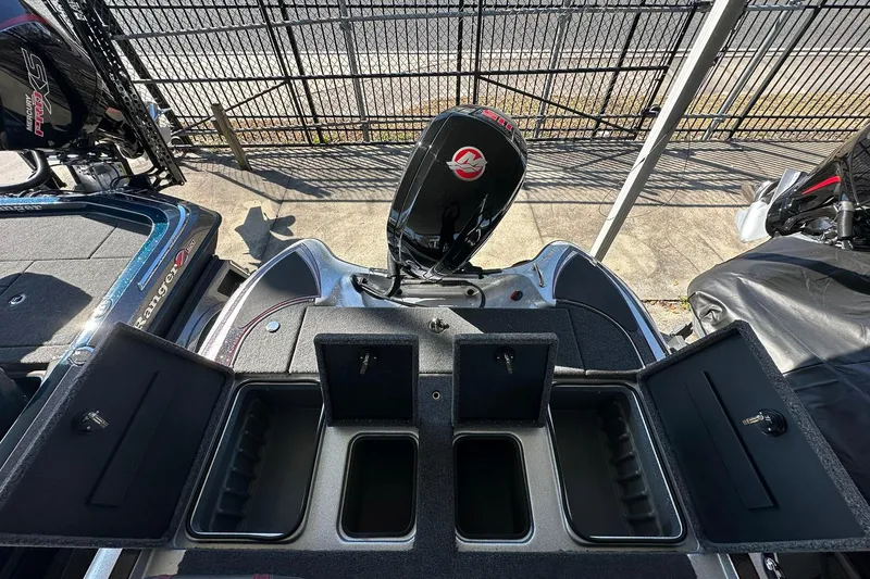 Slide: The Image of 2026 Triton 179 TrX boat with open storage compartments and visible outboard motor. - 23