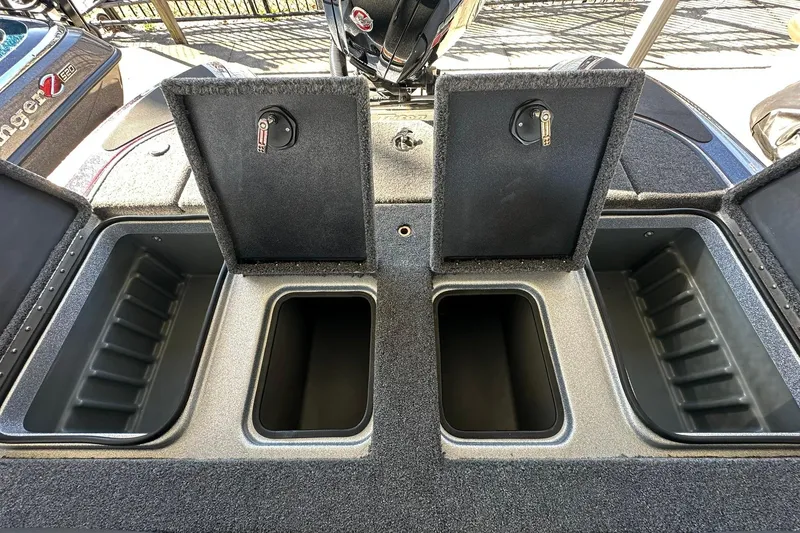 Slide: The Image of 2026 Triton 179 TrX boat storage compartments with open lids, showcasing interior space. - 24