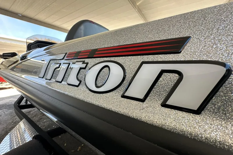 Slide: The Image of 2026 Triton 179 TrX boat with metallic finish and bold logo. - 27