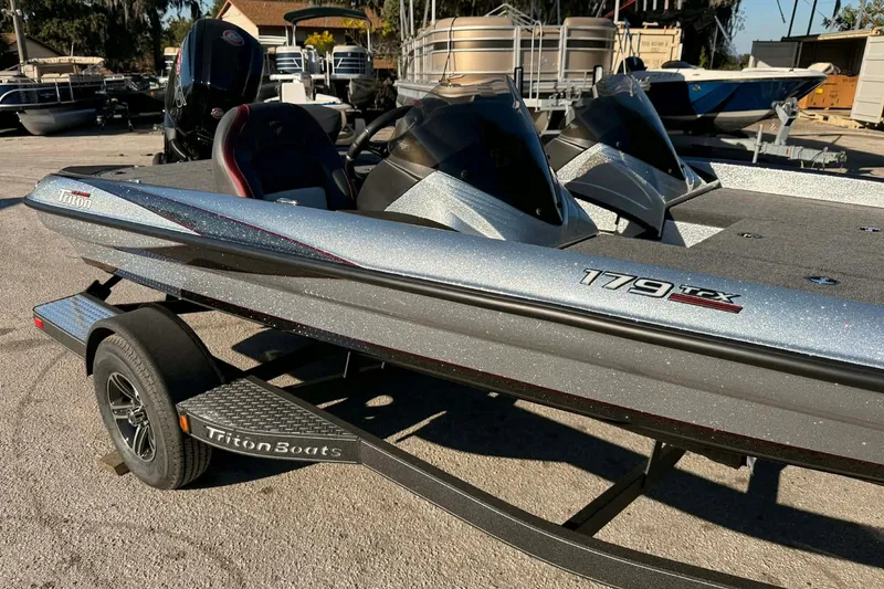 Slide: The Image of 2026 Triton 179 TrX boat with Mercury Pro XS engine, parked outdoors. - 3