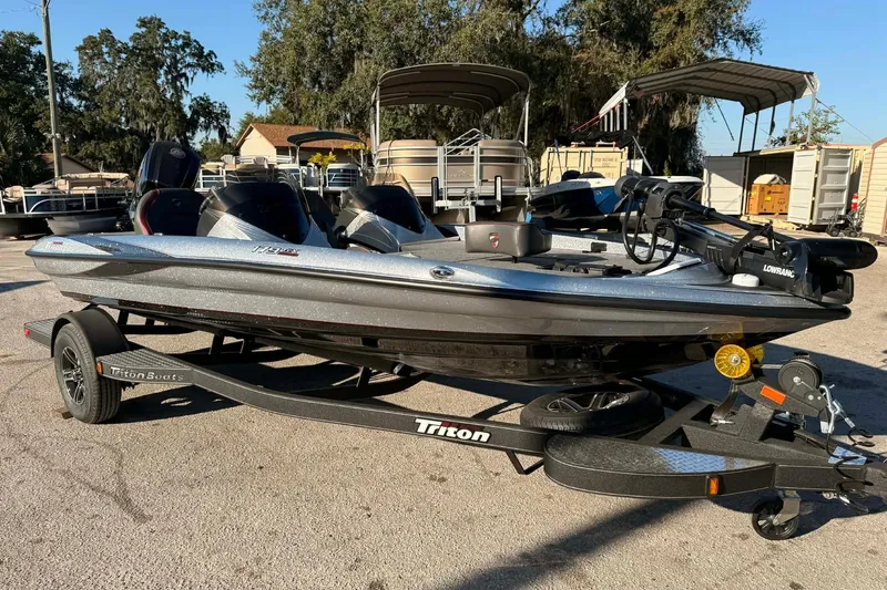 Slide: The Image of 2026 Triton 179 TrX boat logo on a metallic surface, outdoor setting. - 5