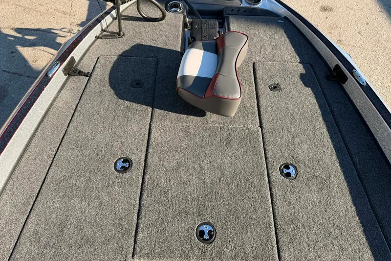 Slide: The Image of 2026 Triton 179 TrX boat deck with carpeted surface and seating. - 6