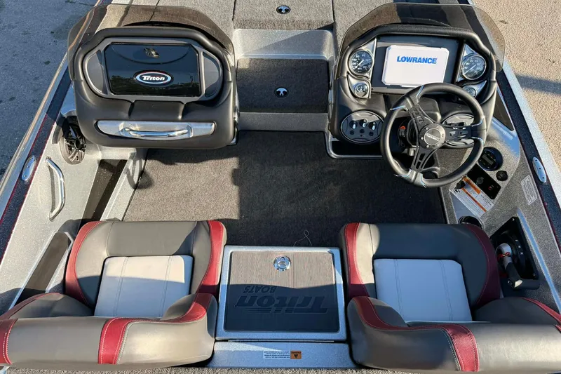 Slide: The Image of 2026 Triton 179 TrX boat storage compartments with fishing gear and equipment. - 8