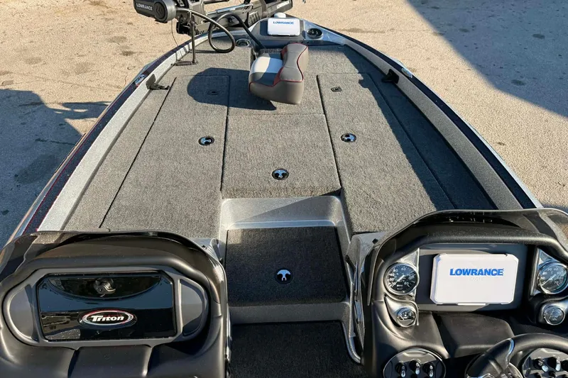 Slide: The Image of 2026 Triton 179 TrX boat storage compartment with open lid and visible interior. - 9