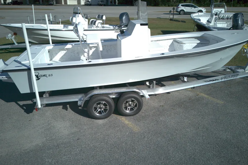 The Image of 2026 C-Hawk 23CC boat on trailer, parked outdoors in a lot. - 1