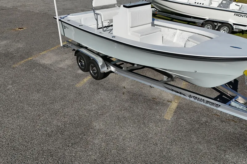 Slide: The Image of 2026 C-Hawk 23CC boat on trailer in parking lot, side view. - 10