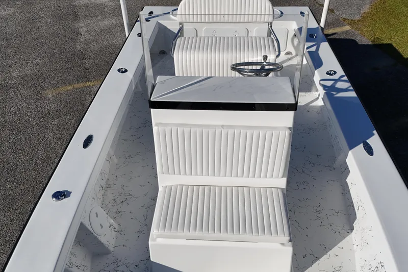 Slide: The Image of 2026 C-Hawk 23CC boat interior with white seating and steering console. - 5