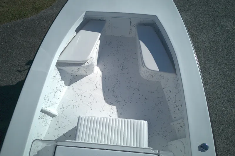 Slide: The Image of 2026 C-Hawk 23CC boat interior with white seating and textured flooring. - 7