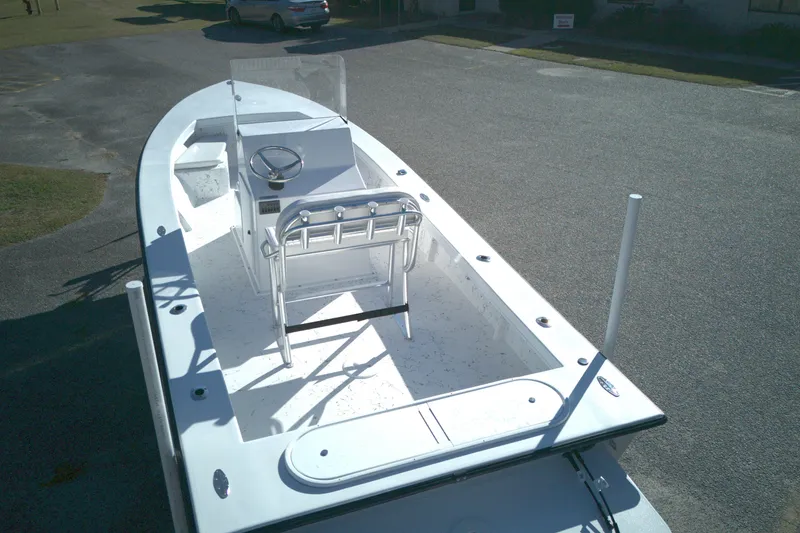 Slide: The Image of 2026 C-Hawk 23CC boat with center console and seating, parked on pavement. - 11