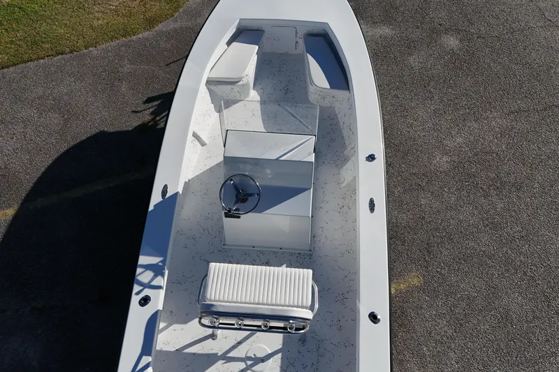Slide: The Image of 2026 C-Hawk 23CC boat interior with steering console and seating, viewed from above. - 12