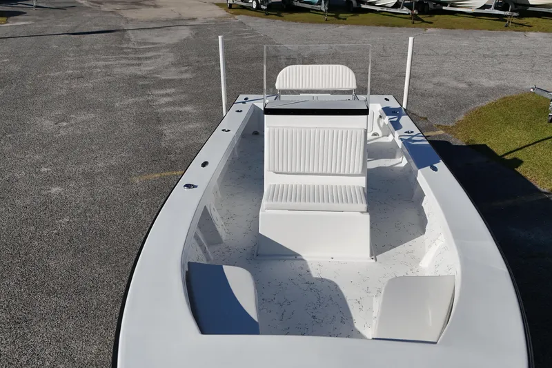 Slide: The Image of 2026 C-Hawk 23CC boat with center console and seating, parked on a paved surface. - 2