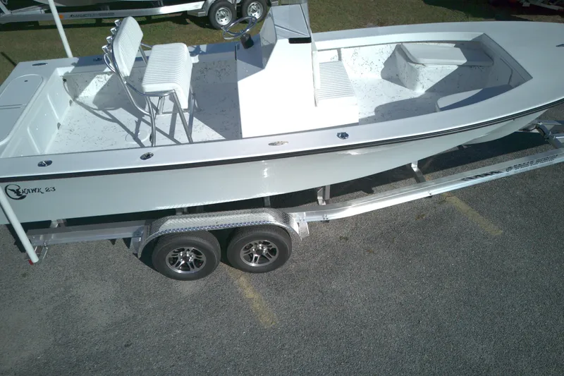 Slide: The Image of 2026 C-Hawk 23CC boat on trailer, featuring dual seats and spacious deck. - 6
