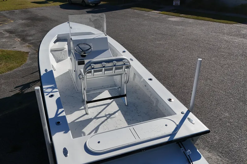 Slide: The Image of 2026 C-Hawk 23CC boat with center console and seating, parked on asphalt. - 8
