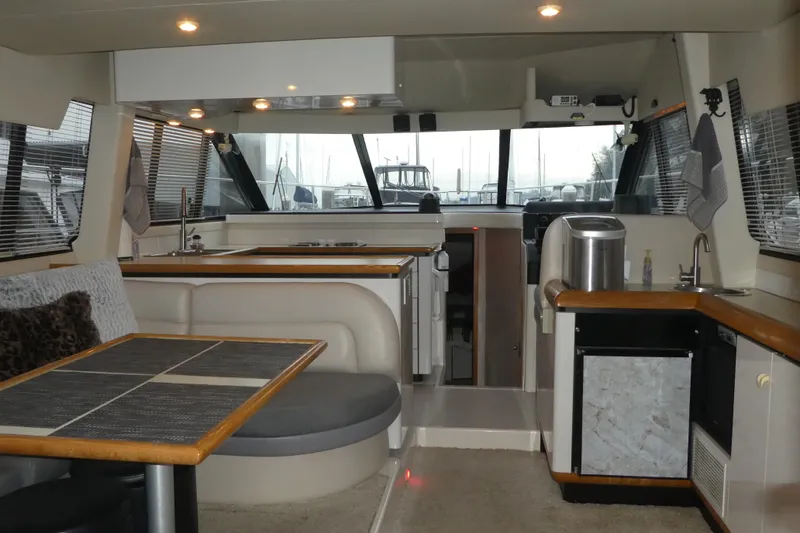 Slide: The Image of Interior of a 1994 Bayliner 4388 Motor Yacht with modern kitchen and seating area. - 10