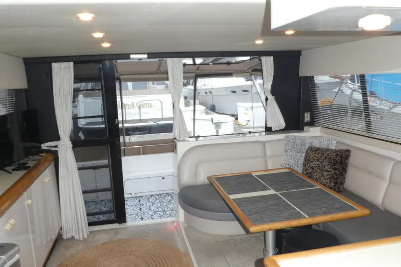 Slide: The Image of Interior of 1994 Bayliner 4388 Motor Yacht with cozy seating and dining area. - 12
