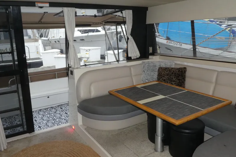Slide: The Image of Interior of 1994 Bayliner 4388 Motor Yacht with dining area and marina view. - 13