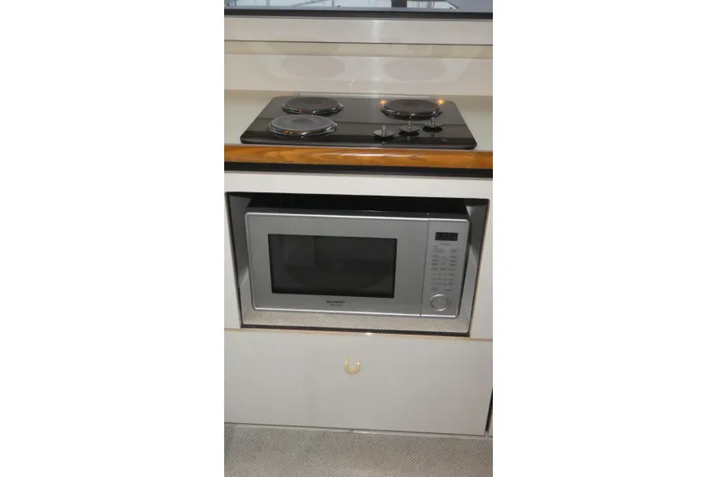 Slide: The Image of Compact kitchen area in 1994 Bayliner 4388 Motor Yacht with stove and microwave. - 16