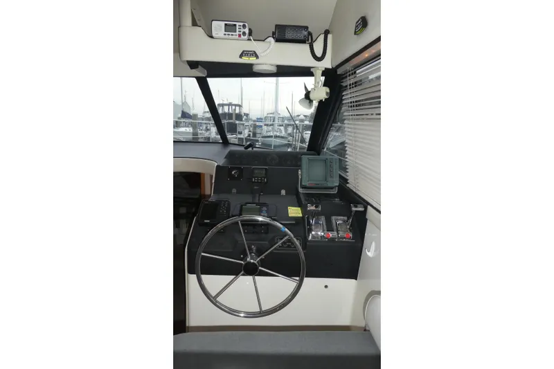 Slide: The Image of 1994 Bayliner 4388 Motor Yacht helm with steering wheel and navigation equipment. - 17