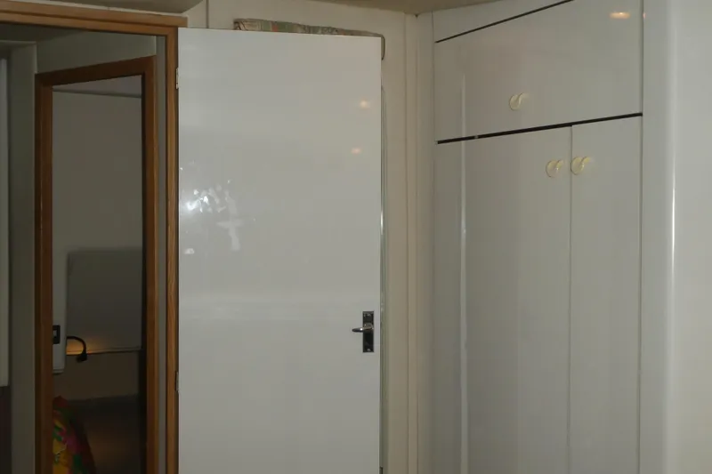 Slide: The Image of Interior of 1994 Bayliner 4388 Motor Yacht with white door and cabinets. - 23