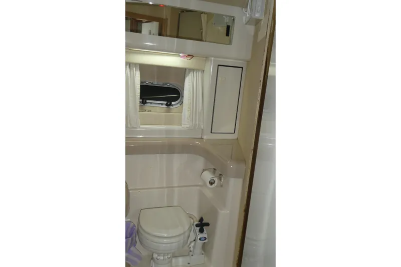 Slide: The Image of Bathroom interior of 1994 Bayliner 4388 Motor Yacht with toilet and mirror. - 25