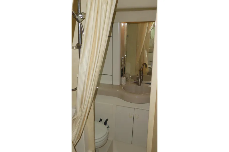 Slide: The Image of Bathroom interior of 1994 Bayliner 4388 Motor Yacht with sink and shower curtain. - 27