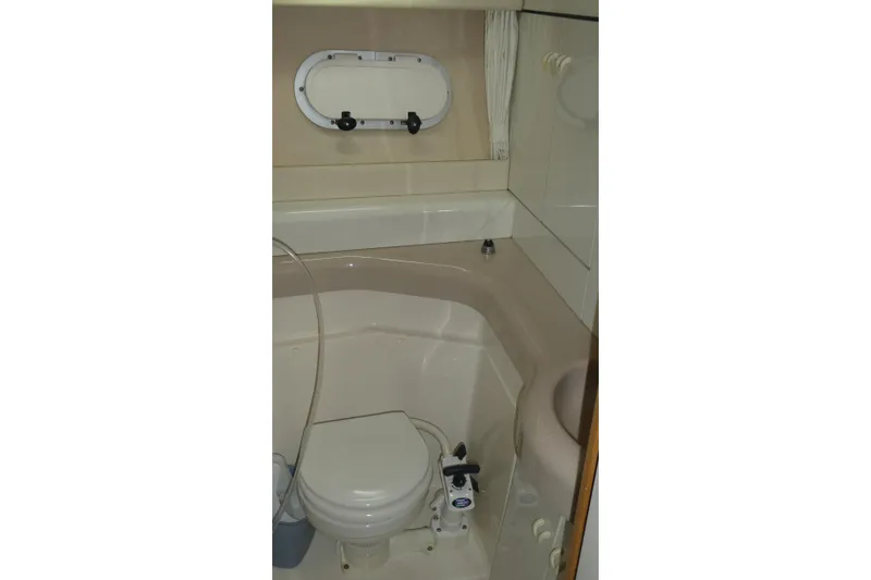 Slide: The Image of Bathroom interior of 1994 Bayliner 4388 Motor Yacht with compact design and porthole window. - 29