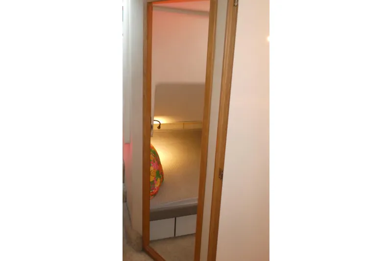 Slide: The Image of Cozy cabin interior of 1994 Bayliner 4388 Motor Yacht with warm lighting. - 31