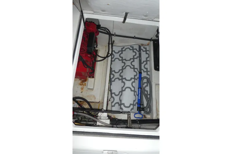 Slide: The Image of Engine compartment of a 1994 Bayliner 4388 Motor Yacht with visible equipment and hoses. - 33