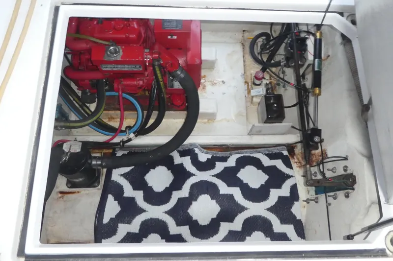 Slide: The Image of Engine compartment of 1994 Bayliner 4388 Motor Yacht with visible machinery and hoses. - 34