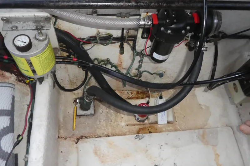 Slide: The Image of Engine compartment of a 1994 Bayliner 4388 Motor Yacht, showing hoses and mechanical components. - 38