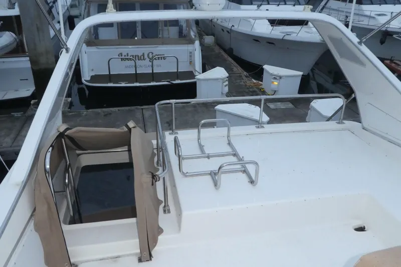 Slide: The Image of 1994 Bayliner 4388 Motor Yacht deck view at marina, featuring railing and hatch. - 40