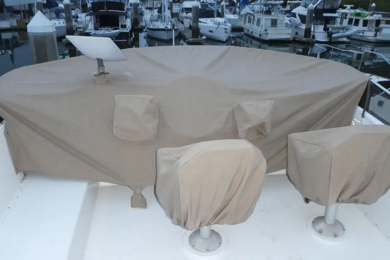 Slide: The Image of 1994 Bayliner 4388 Motor Yacht with covered seating and equipment at a marina. - 41