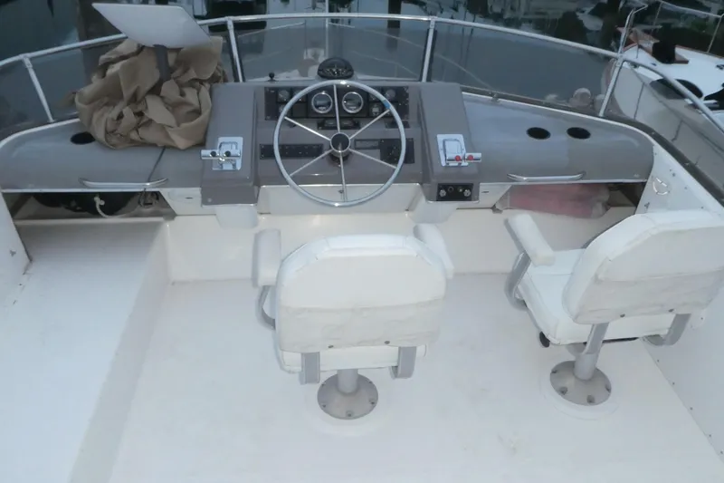 Slide: The Image of 1994 Bayliner 4388 Motor Yacht helm with dual seats and steering wheel. - 42