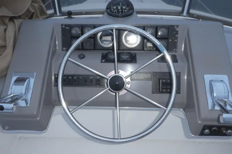 Slide: The Image of 1994 Bayliner 4388 Motor Yacht helm with steering wheel and control panel. - 43